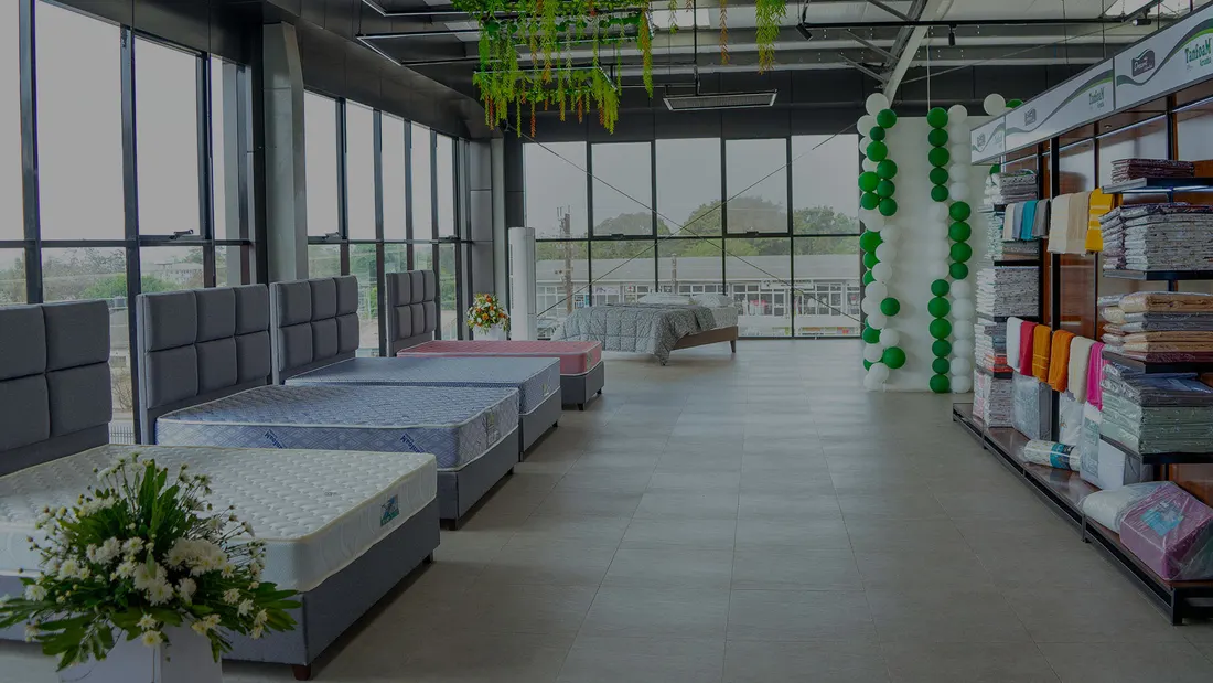 Mattress displays inside a Tanfoam-branded showroom